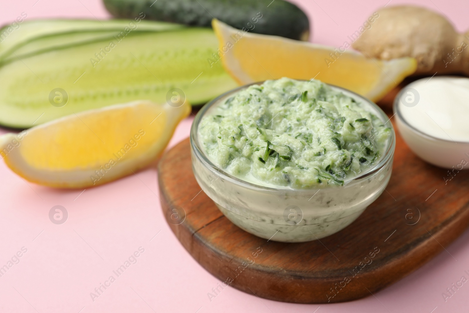 Photo of Handmade face mask in glass bowl and ingredients on pink background