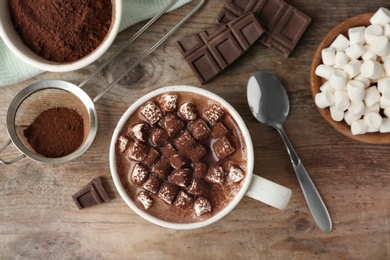 Photo of Composition with delicious hot cocoa drink and marshmallows on wooden background, flat lay