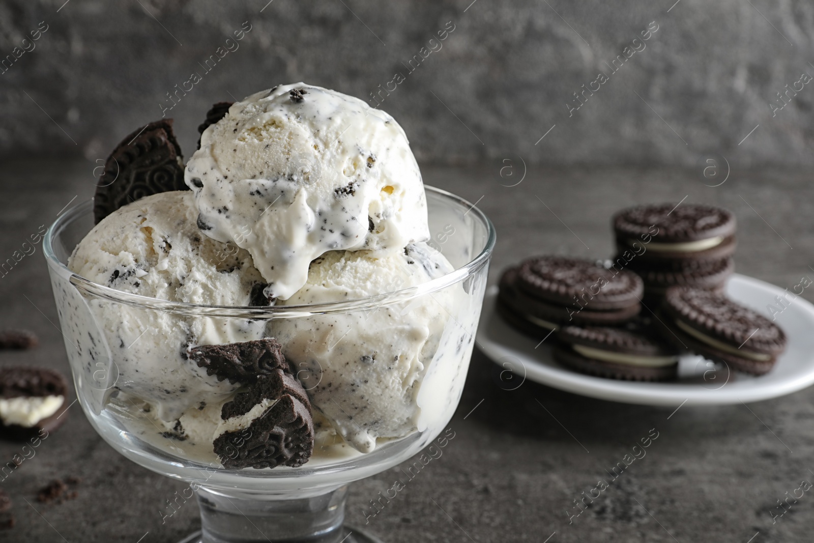 Photo of Bowl of chocolate cookies ice cream on table, closeup. Space for text