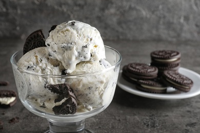 Photo of Bowl of chocolate cookies ice cream on table, closeup. Space for text