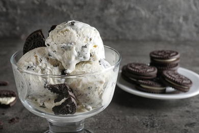 Bowl of chocolate cookies ice cream on table, closeup. Space for text