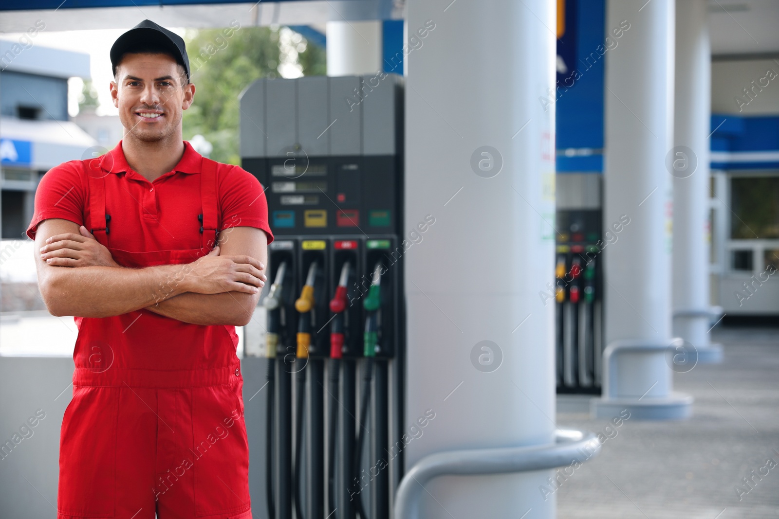 Photo of Worker in uniform at modern gas station