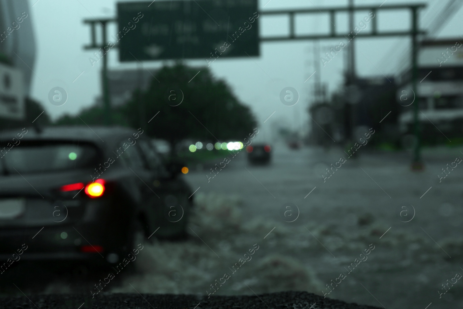 Photo of Road on rainy day, view through car window with water drops