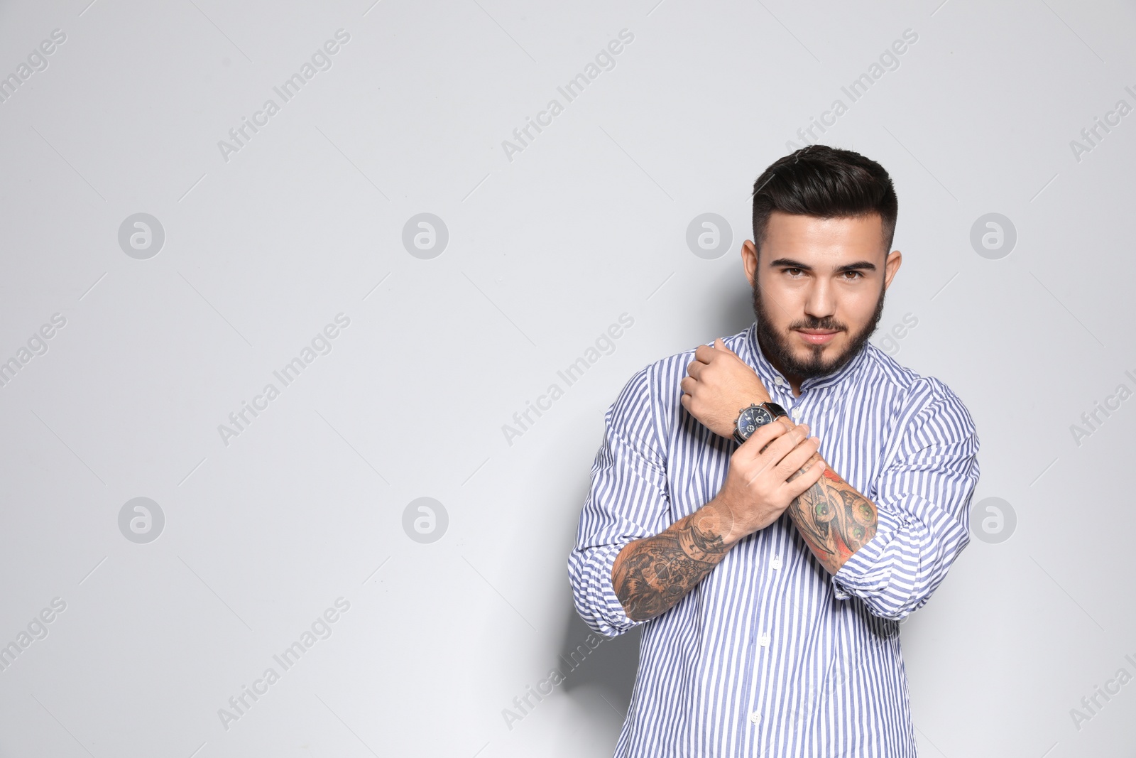 Photo of Portrait of handsome young man against light background. Space for text