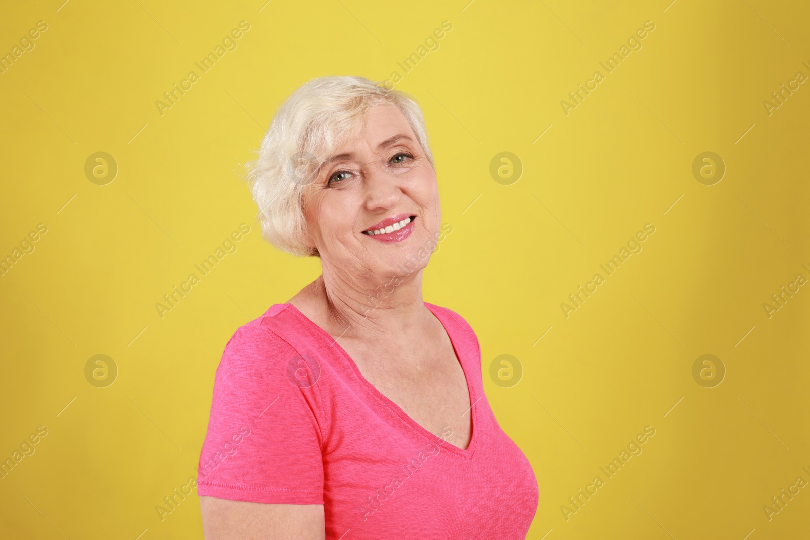 Photo of Senior woman in casual outfit on yellow background