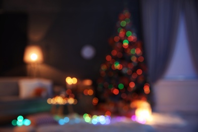 Photo of Blurred view of stylish room interior with decorated Christmas tree