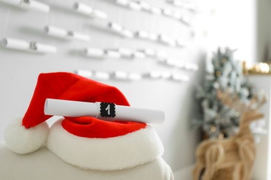 Red Santa hat and Christmas advent calendar gift at home