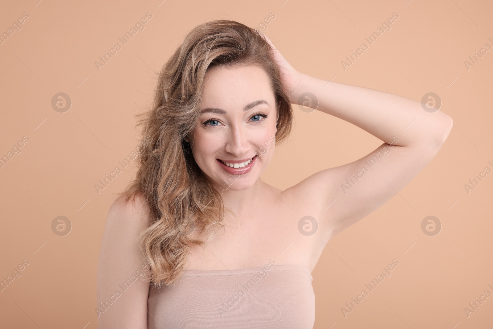 Photo of Portrait of smiling woman on beige background