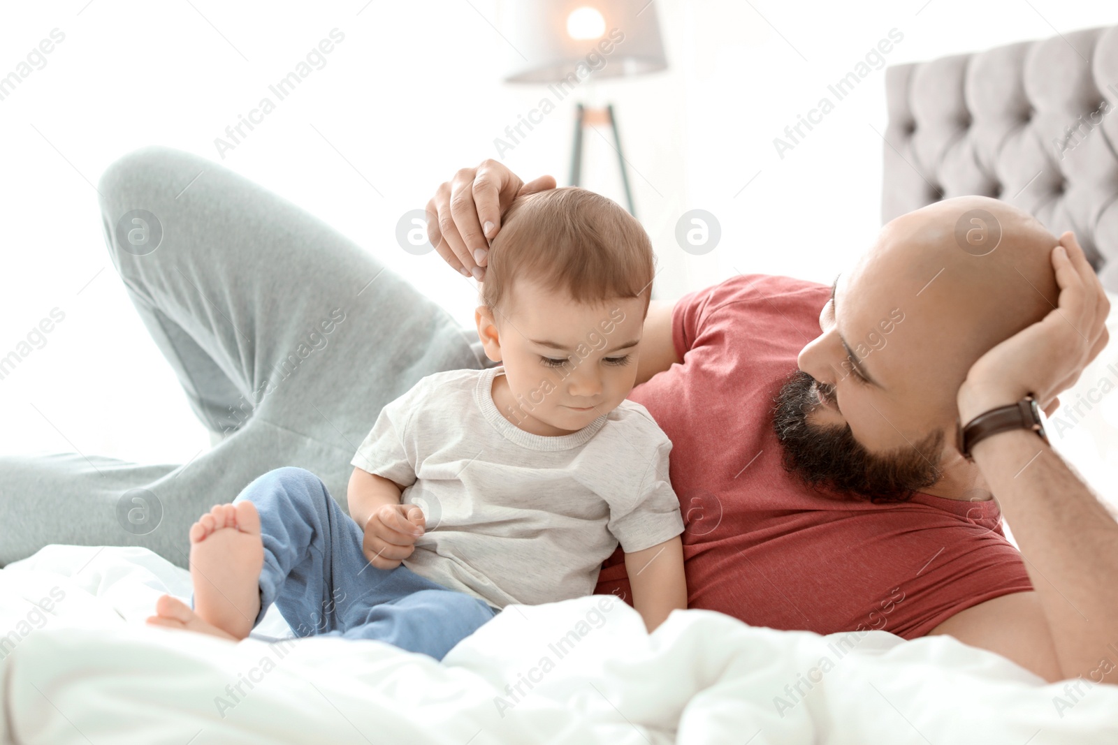 Photo of Dad and his little son spending time together at home