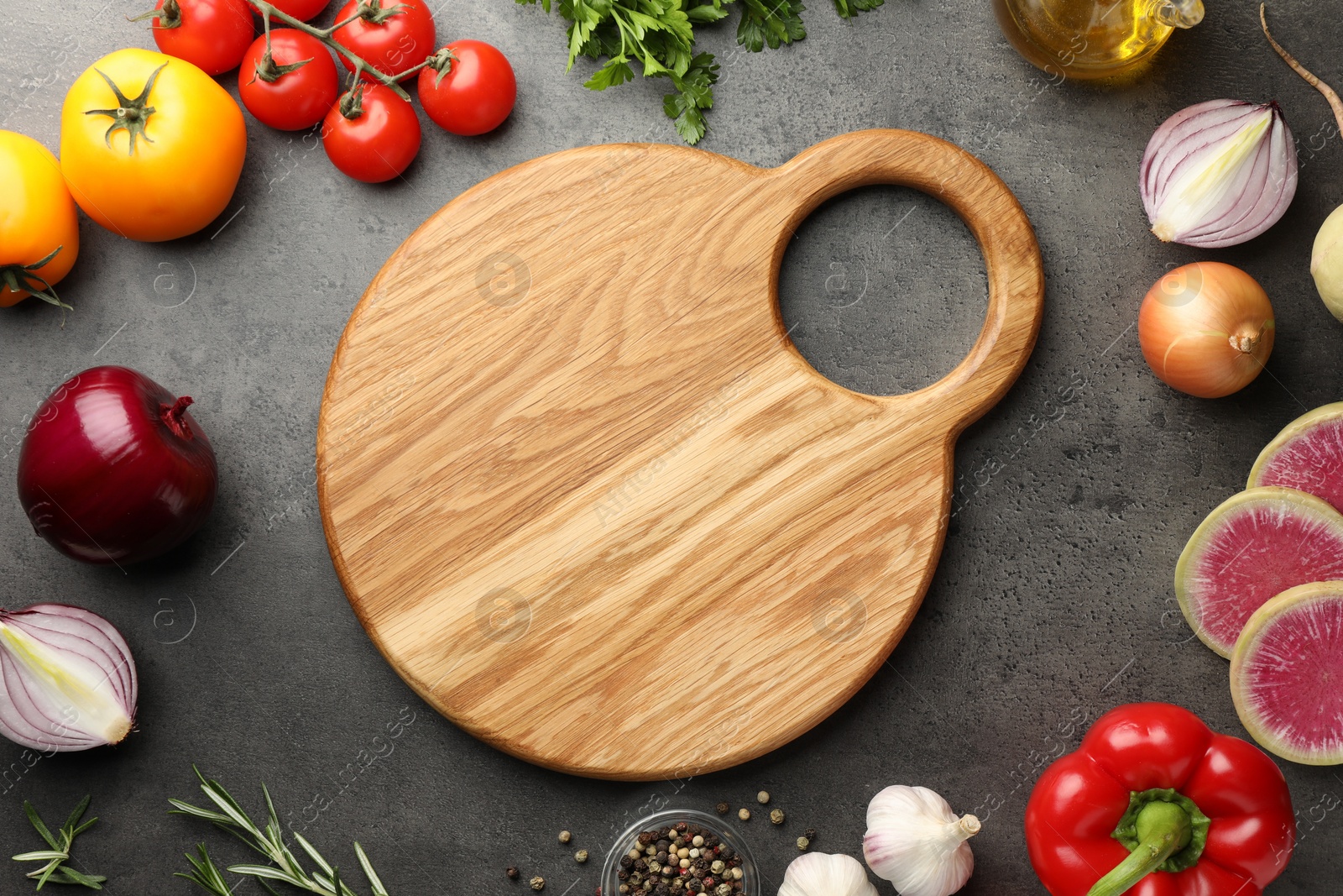 Photo of Flat lay composition with wooden cutting board and products on dark textured table