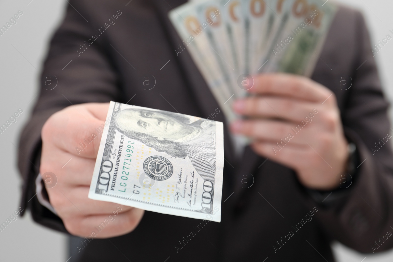 Photo of Man holding money on white background, closeup. Currency exchange