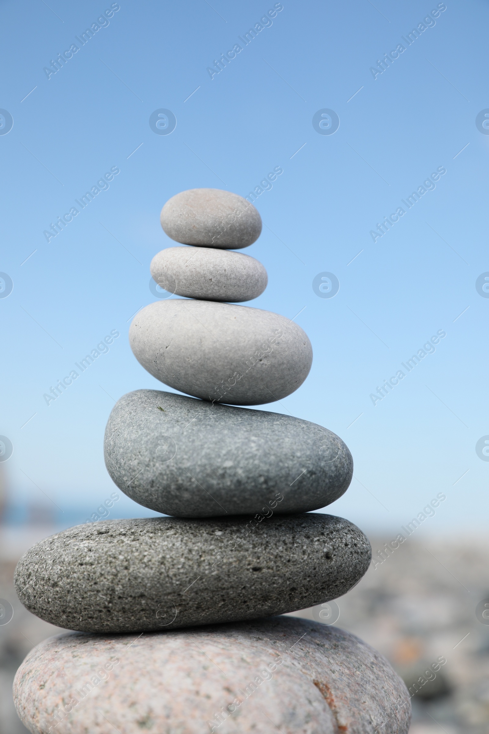 Photo of Stack of stones on beach against blurred background, closeup