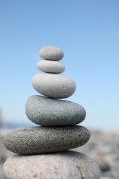 Stack of stones on beach against blurred background, closeup