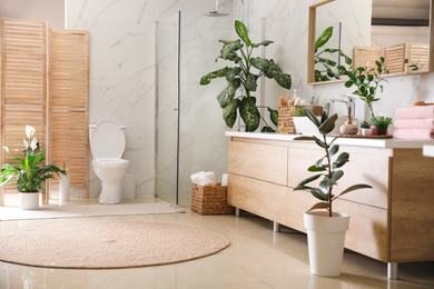 Photo of Elegant interior of modern bathroom with green plants