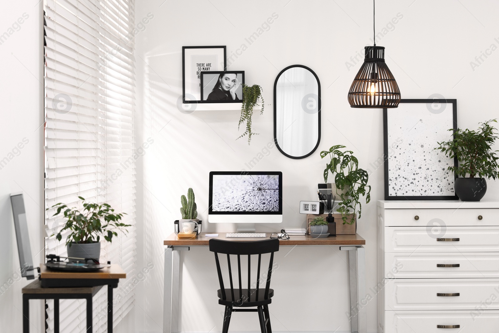 Photo of Cozy workspace with computer on wooden desk at home