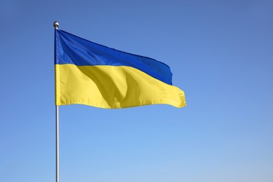 Photo of National flag of Ukraine against blue sky