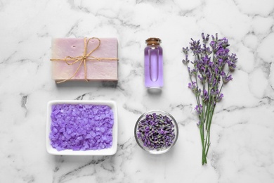 Photo of Flat lay composition with natural cosmetic products and lavender flowers on marble background