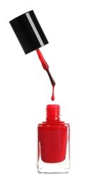 Brush over nail polish bottle on white background