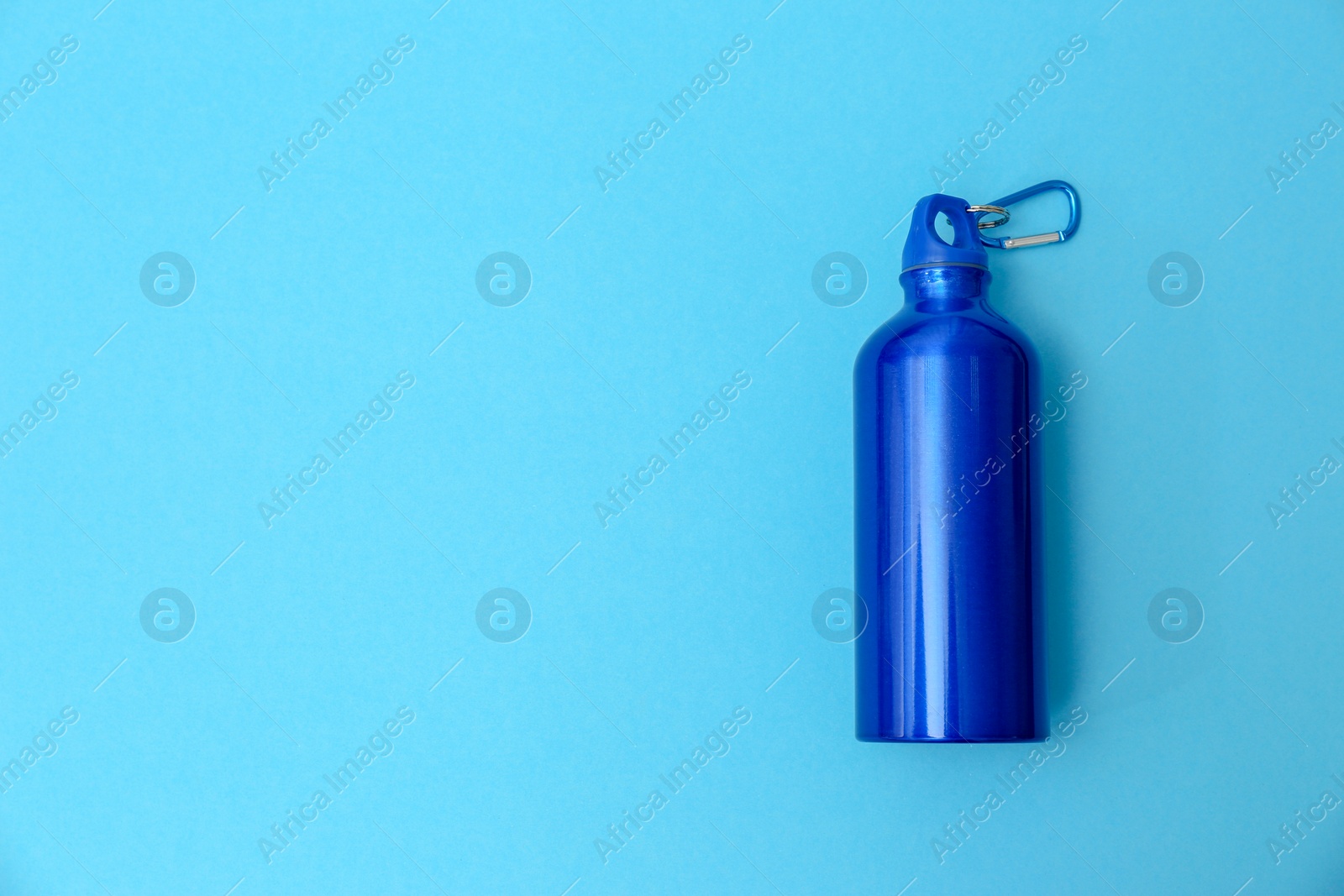 Photo of Sport bottle with space for text on color background, top view