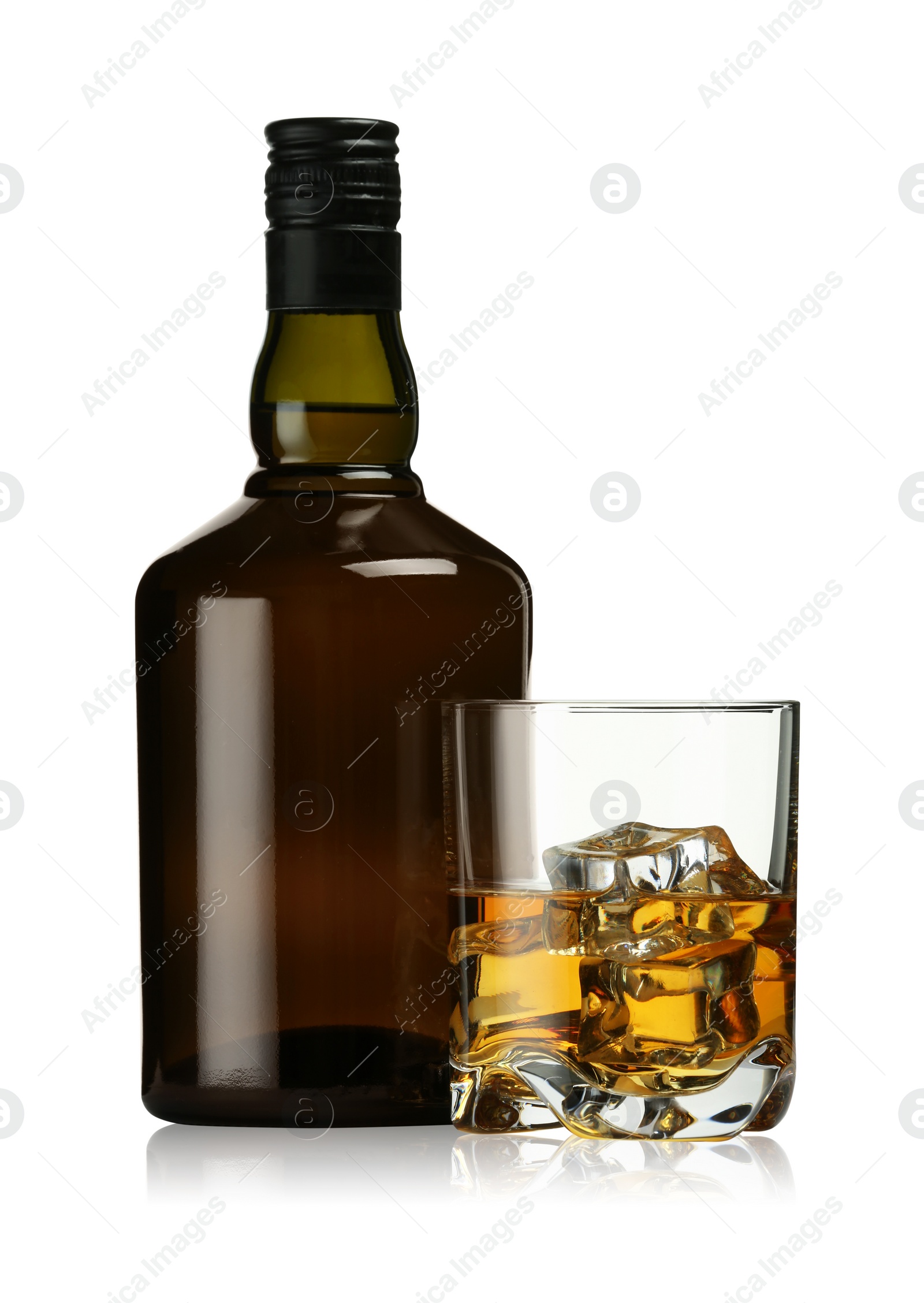 Photo of Whiskey in glass and bottle isolated on white