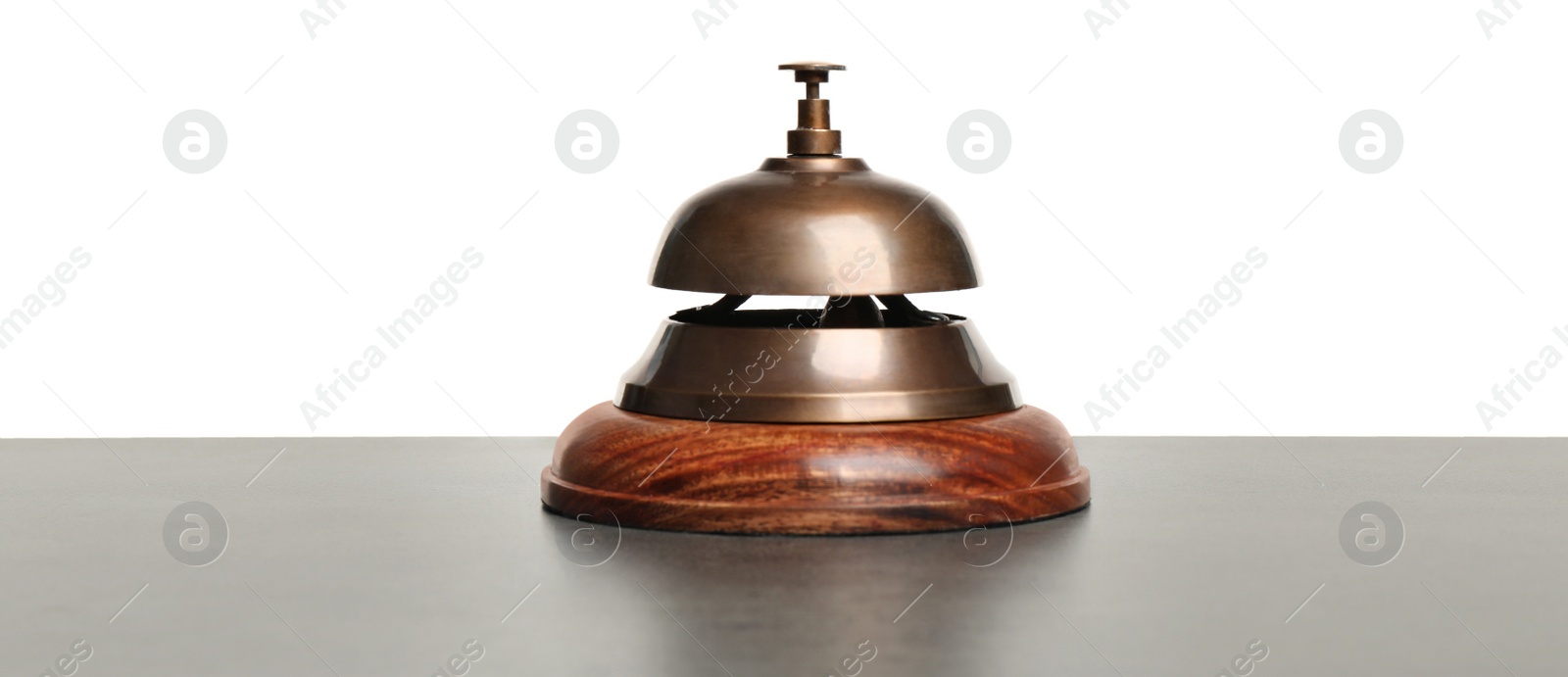 Photo of Hotel service bell on grey stone table against white background