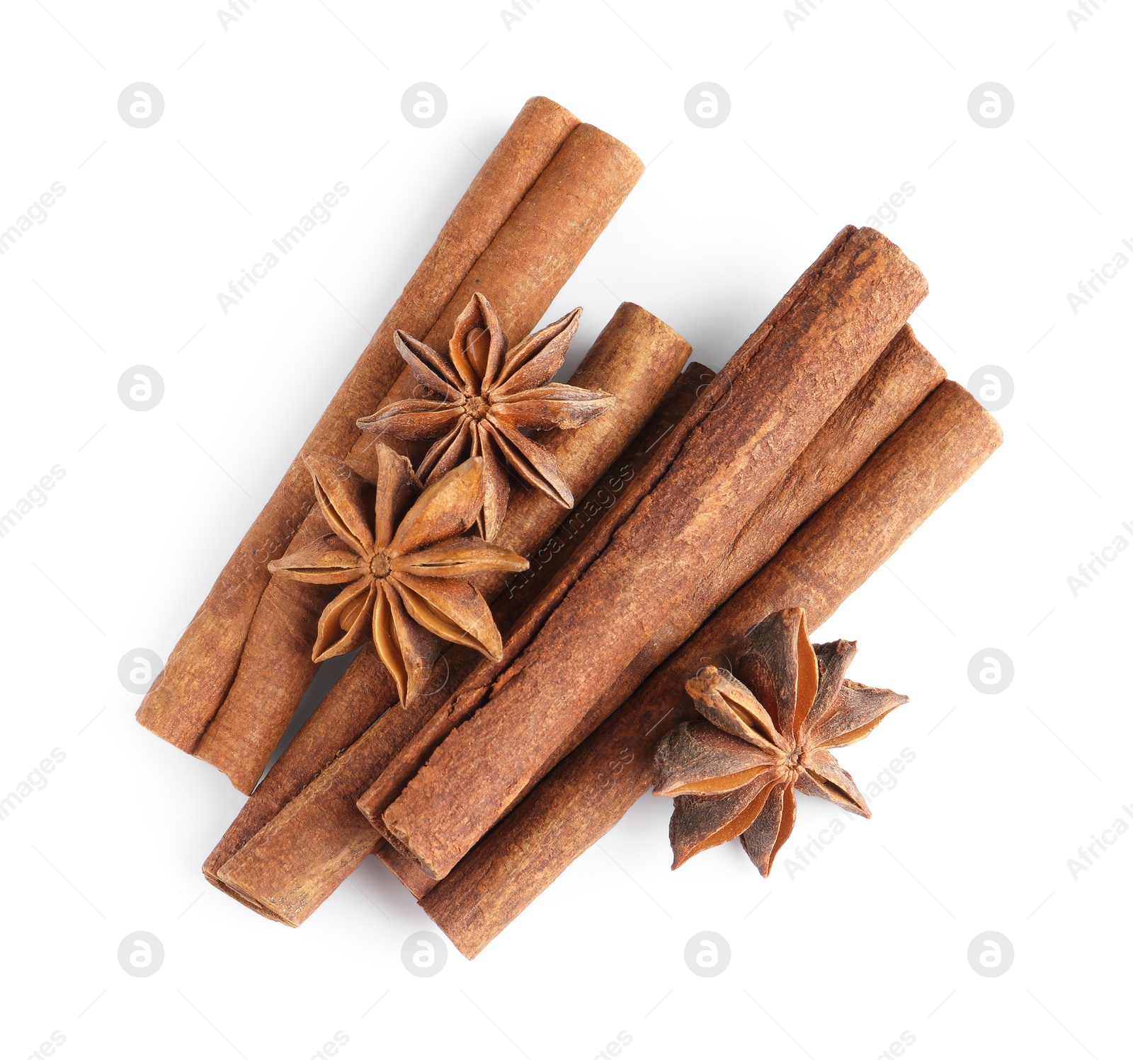 Photo of Cinnamon sticks and anise stars isolated on white, top view