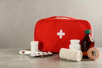 Photo of First aid kit on grey table. Space for text