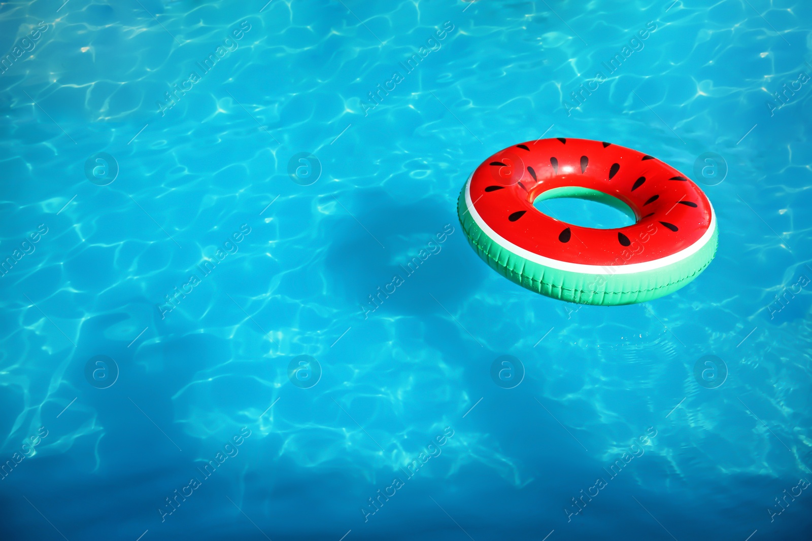 Photo of Inflatable ring floating in swimming pool on sunny day