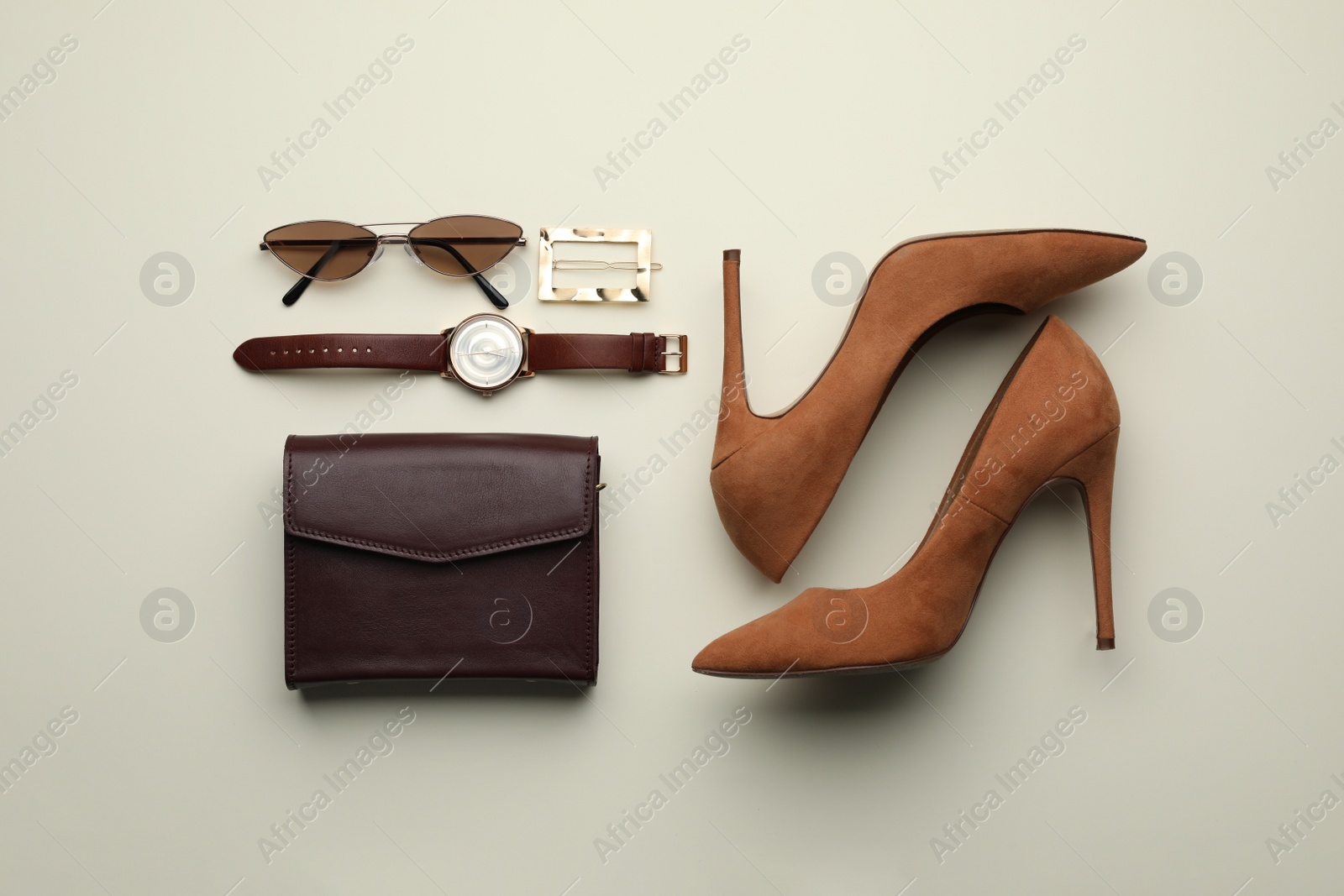 Photo of Stylish woman's bag, shoes and accessories on light background, flat lay