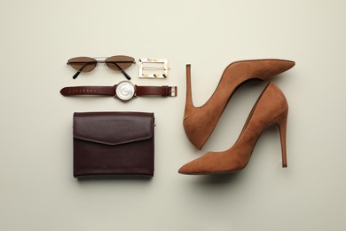 Photo of Stylish woman's bag, shoes and accessories on light background, flat lay