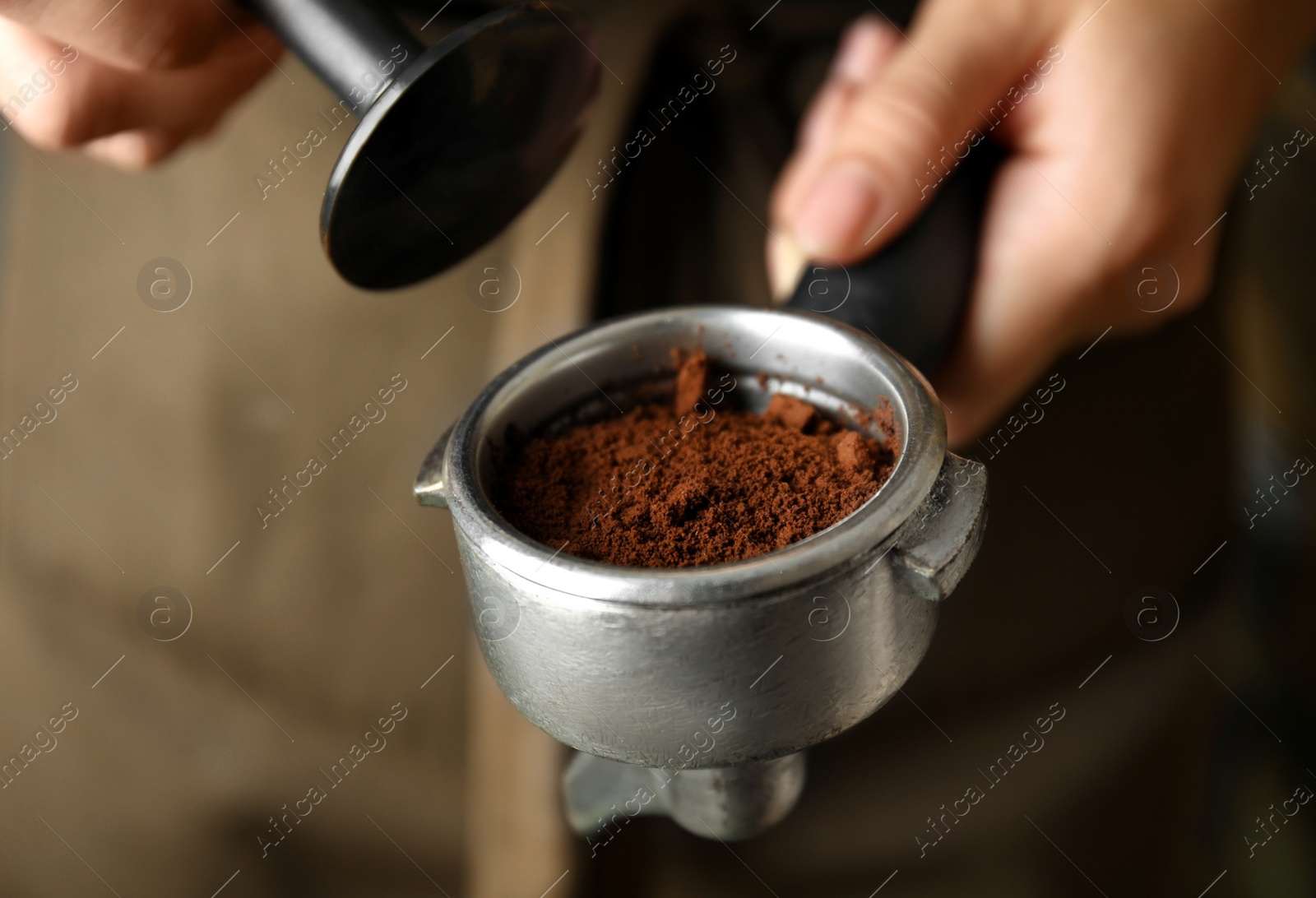 Photo of Barista making espresso using professional coffee machine, closeup