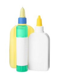 Photo of Different bottles and stick of glue on white background