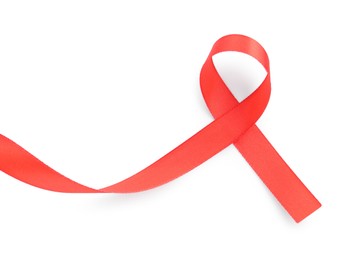 Photo of Red awareness ribbon isolated on white, top view