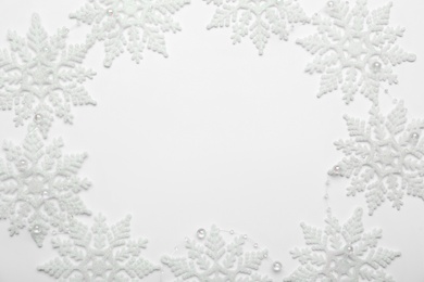 Beautiful decorative snowflakes on white background, flat lay. Space for text