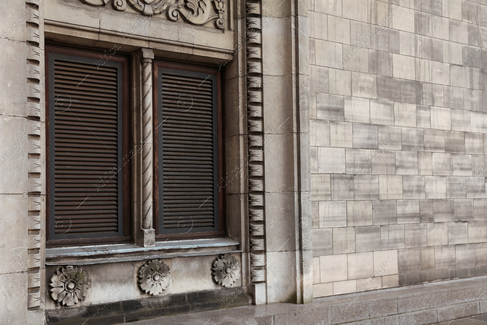 Photo of Window with closed shutters in building outdoors, space for text