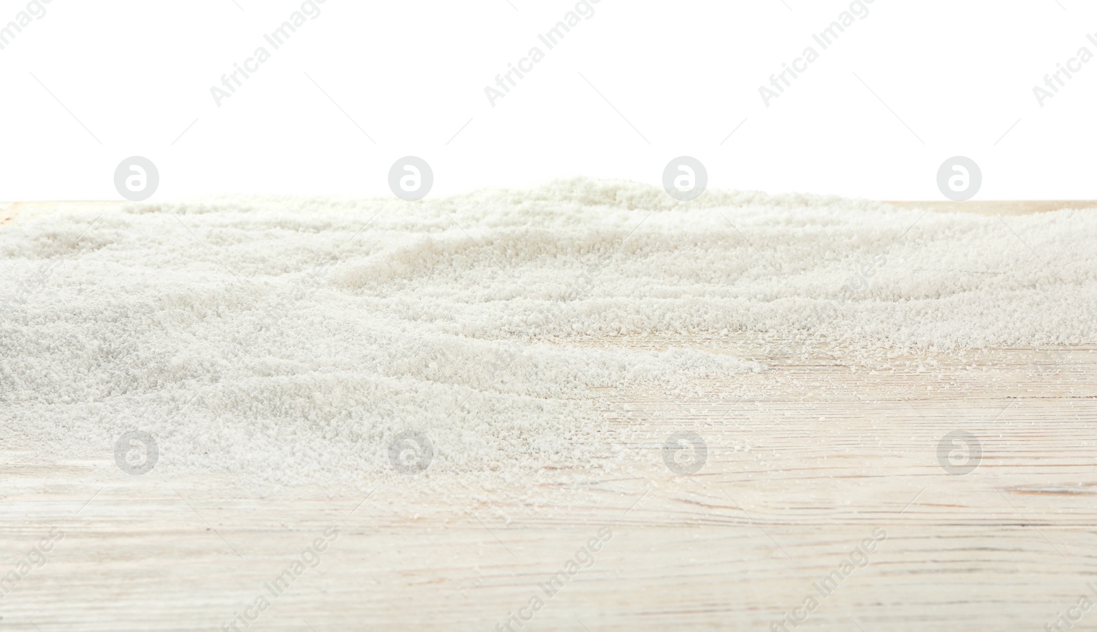 Photo of Artificial snow on wooden table against white background. Christmas decor