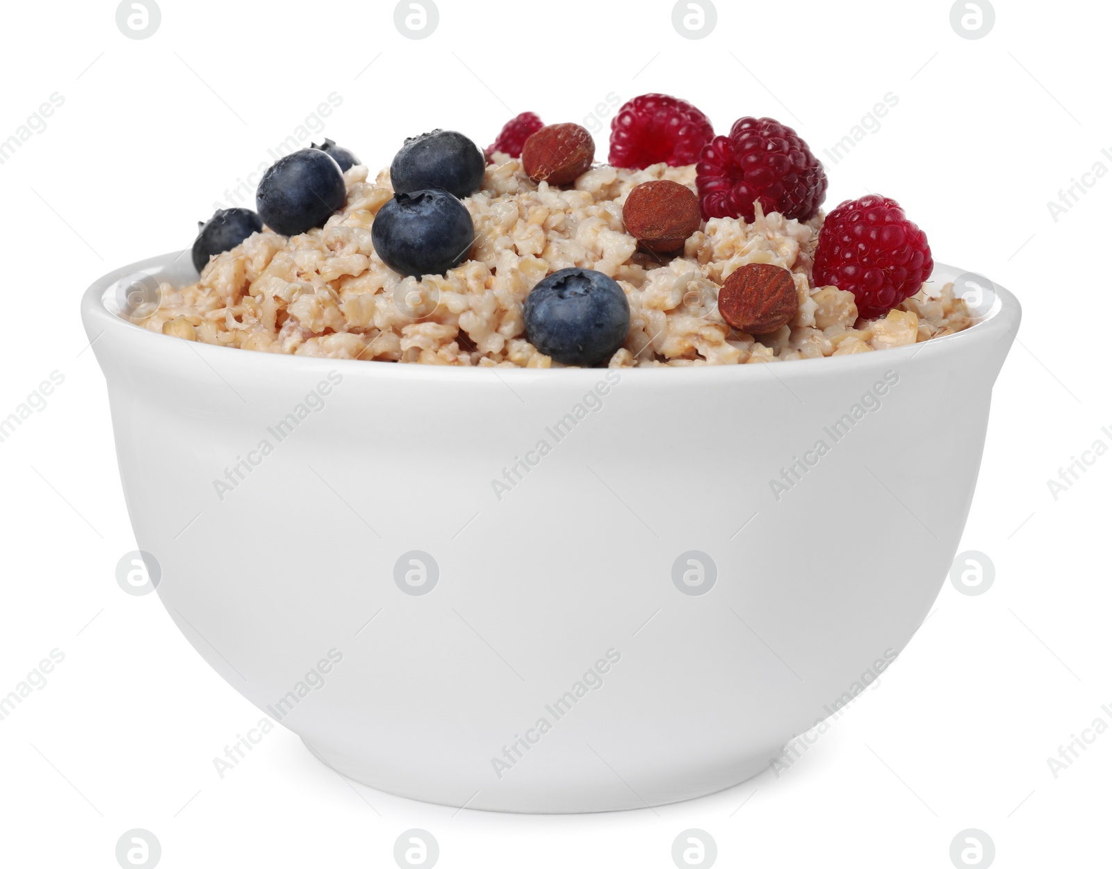 Photo of Tasty boiled oatmeal with berries and almonds in bowl isolated on white