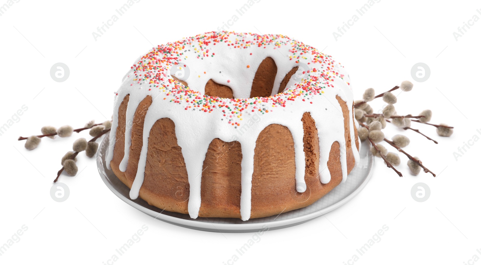 Photo of Glazed Easter cake with sprinkles and willow branches on white background