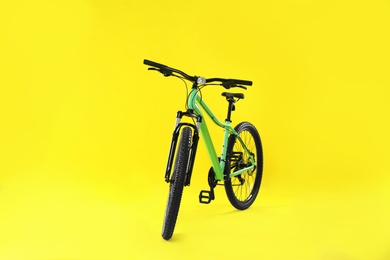 Modern bicycle on yellow background. Healthy lifestyle