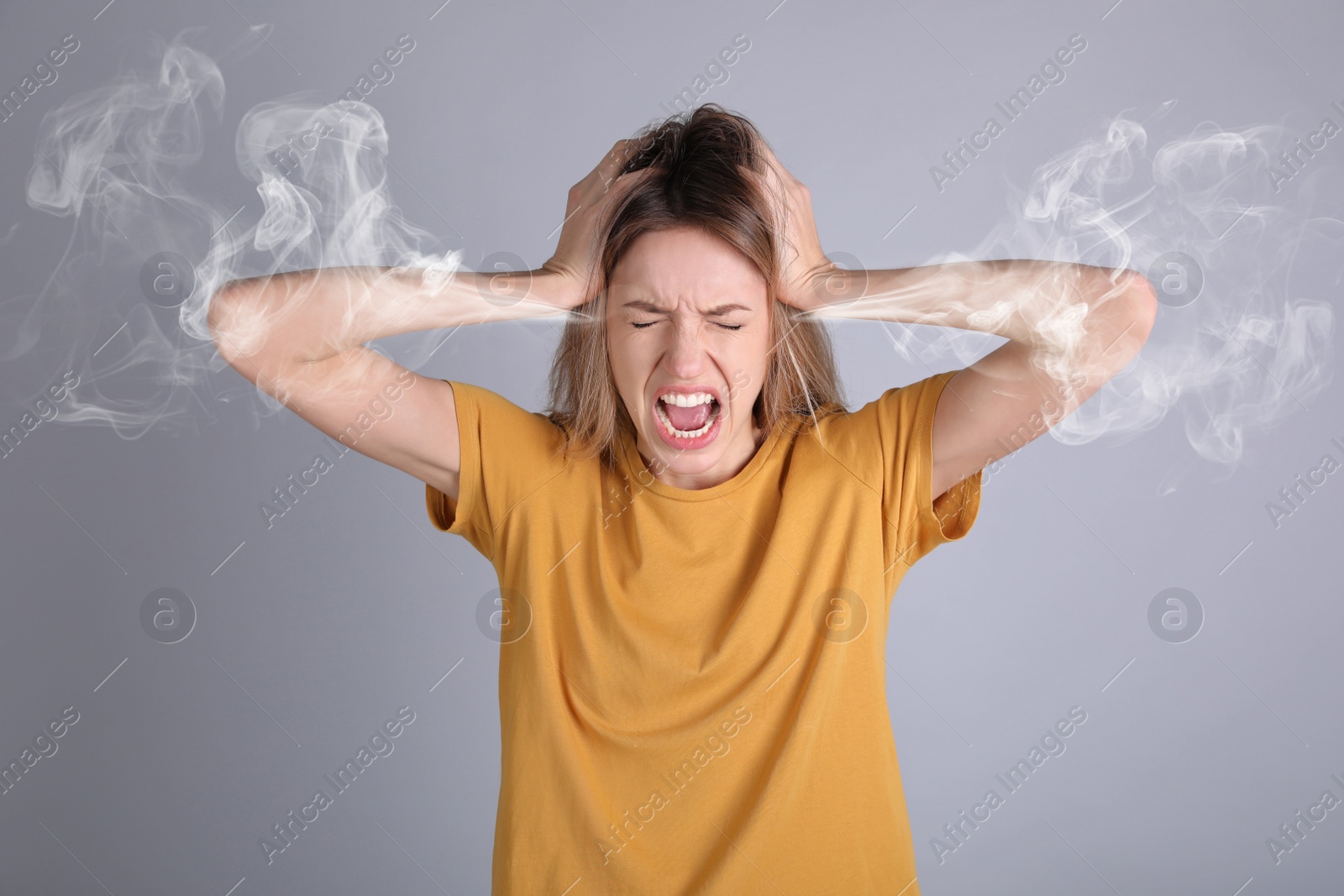 Image of Stressed and upset young woman on grey background