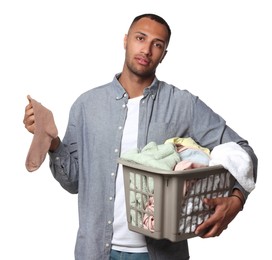 Young man with basket full of laundry on white background