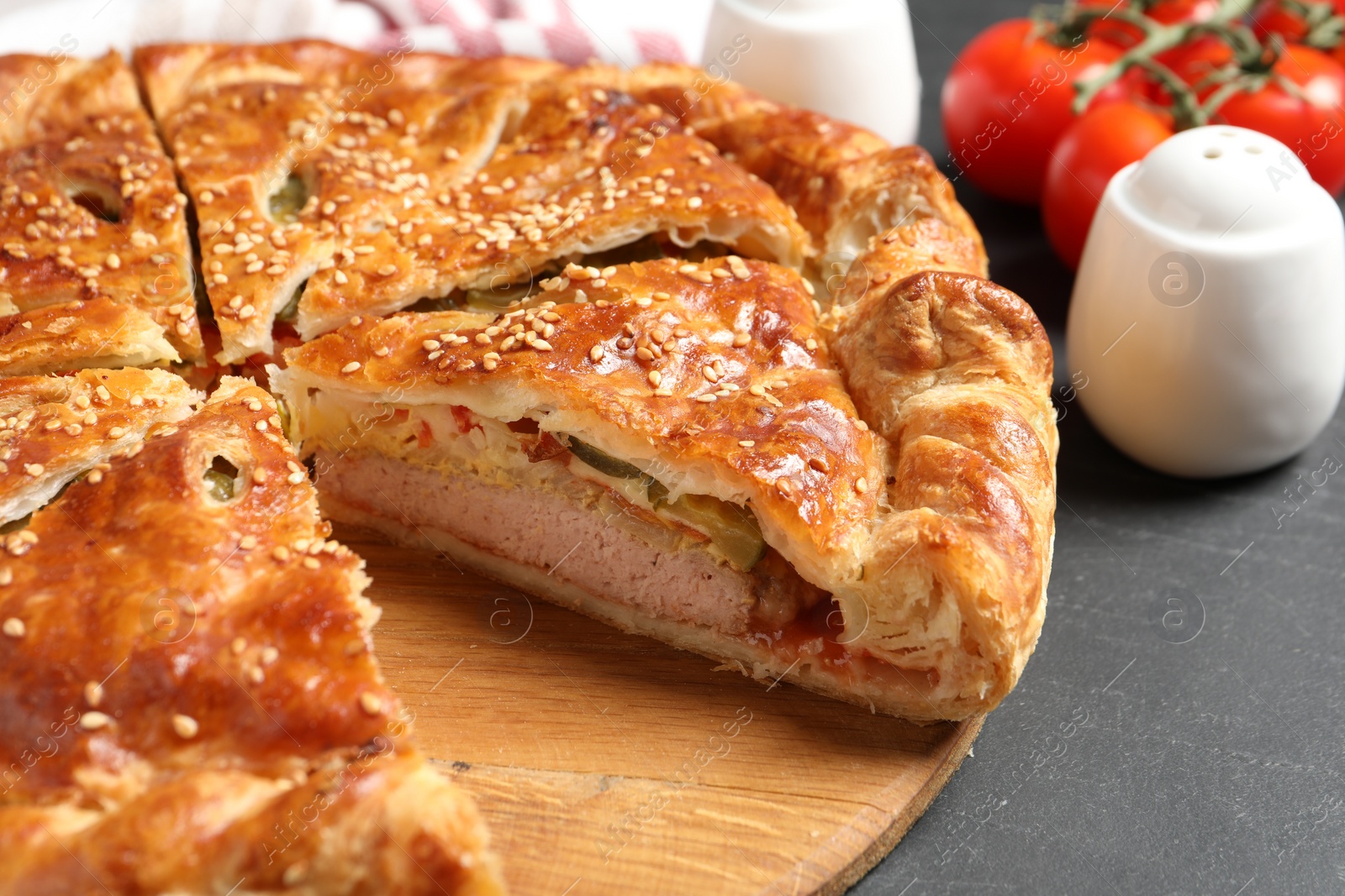 Photo of Cut delicious homemade pie on black table, closeup