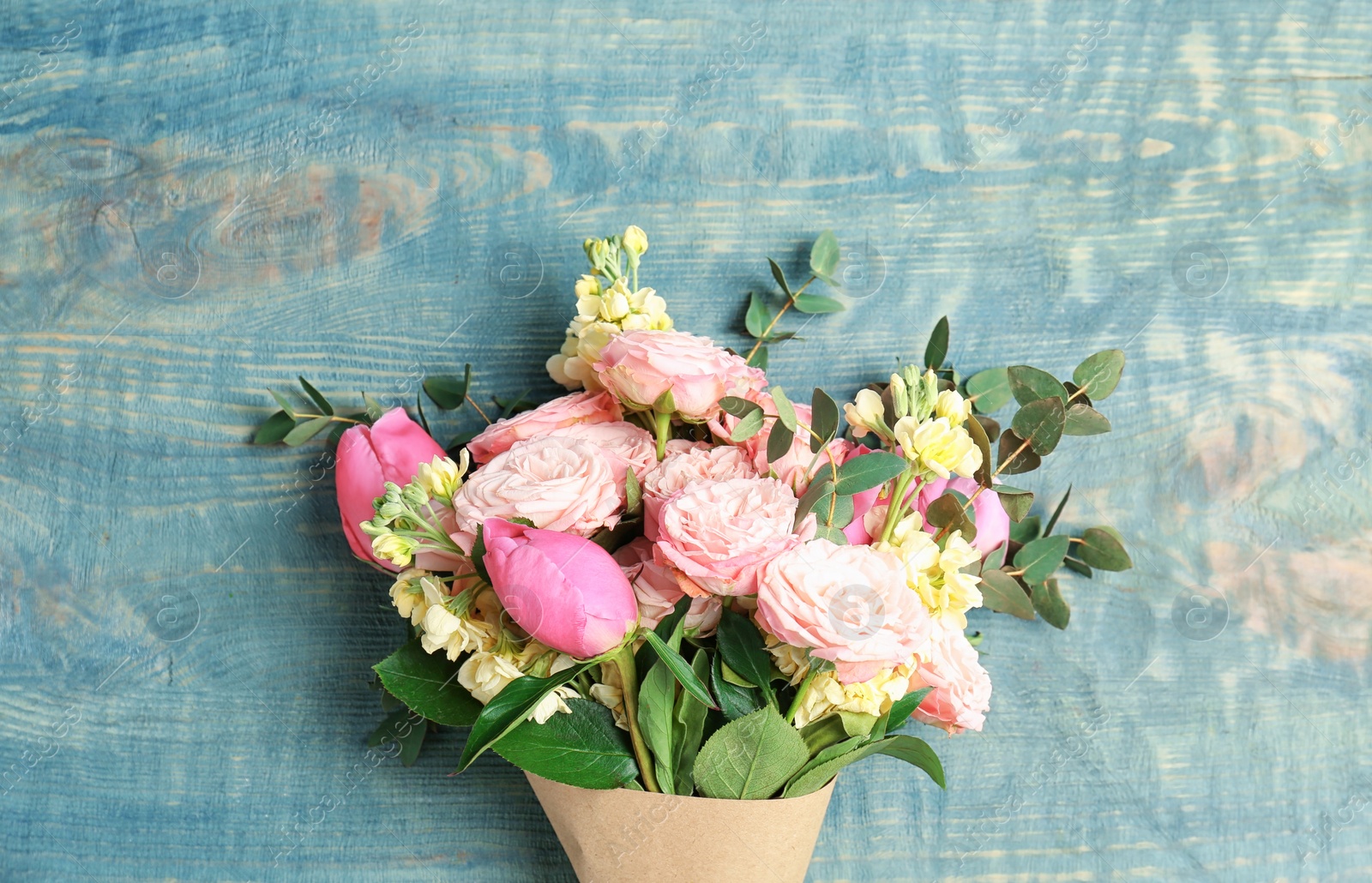 Photo of Bouquet of beautiful fragrant flowers on wooden background