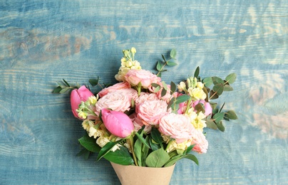 Photo of Bouquet of beautiful fragrant flowers on wooden background