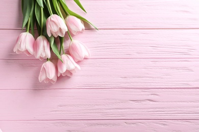 Beautiful tulips for Mother's Day on wooden background, top view