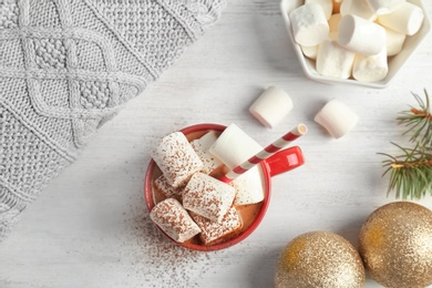 Photo of Flat lay composition with hot cocoa drink and marshmallows on wooden background