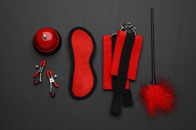 Photo of Sex toys and accessories on black background, flat lay