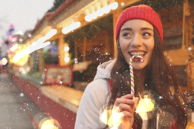 Image of Young woman spending time at Christmas fair, space for text