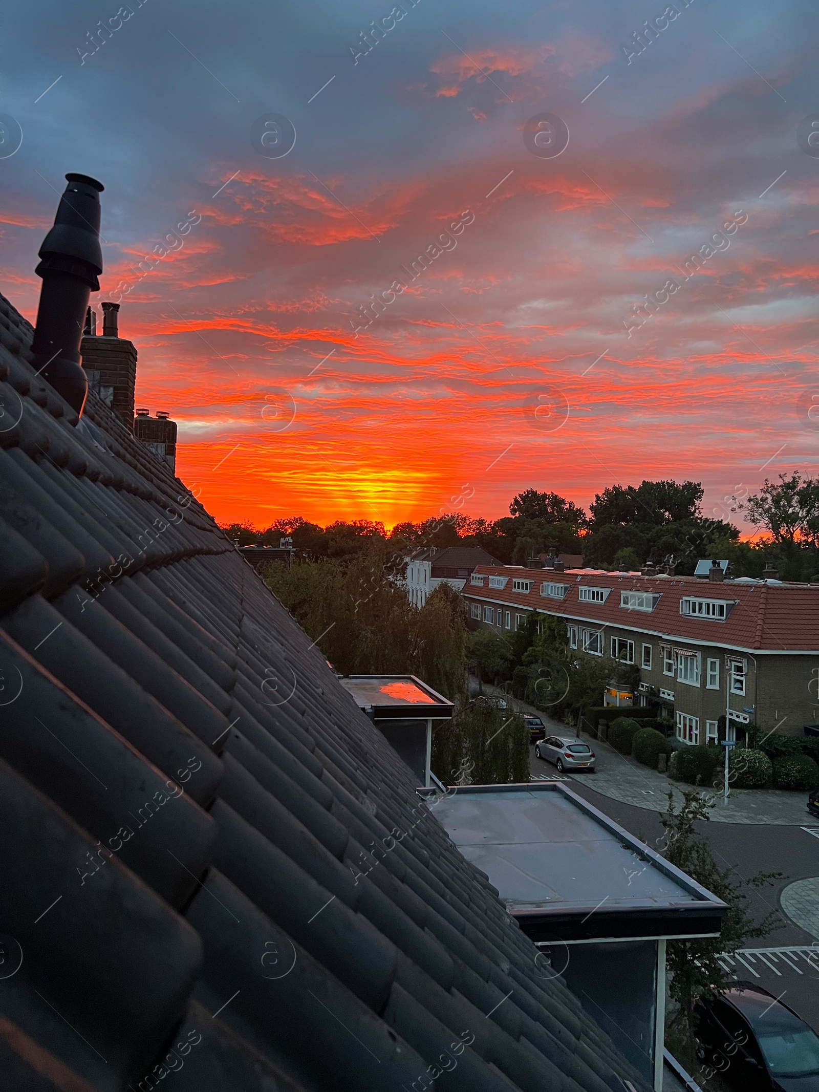 Photo of Picturesque view of city street with beautiful buildings at sunrise