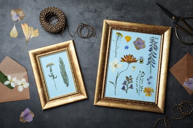 Frames with pressed dried flowers and plants on black table, flat lay. Beautiful herbarium